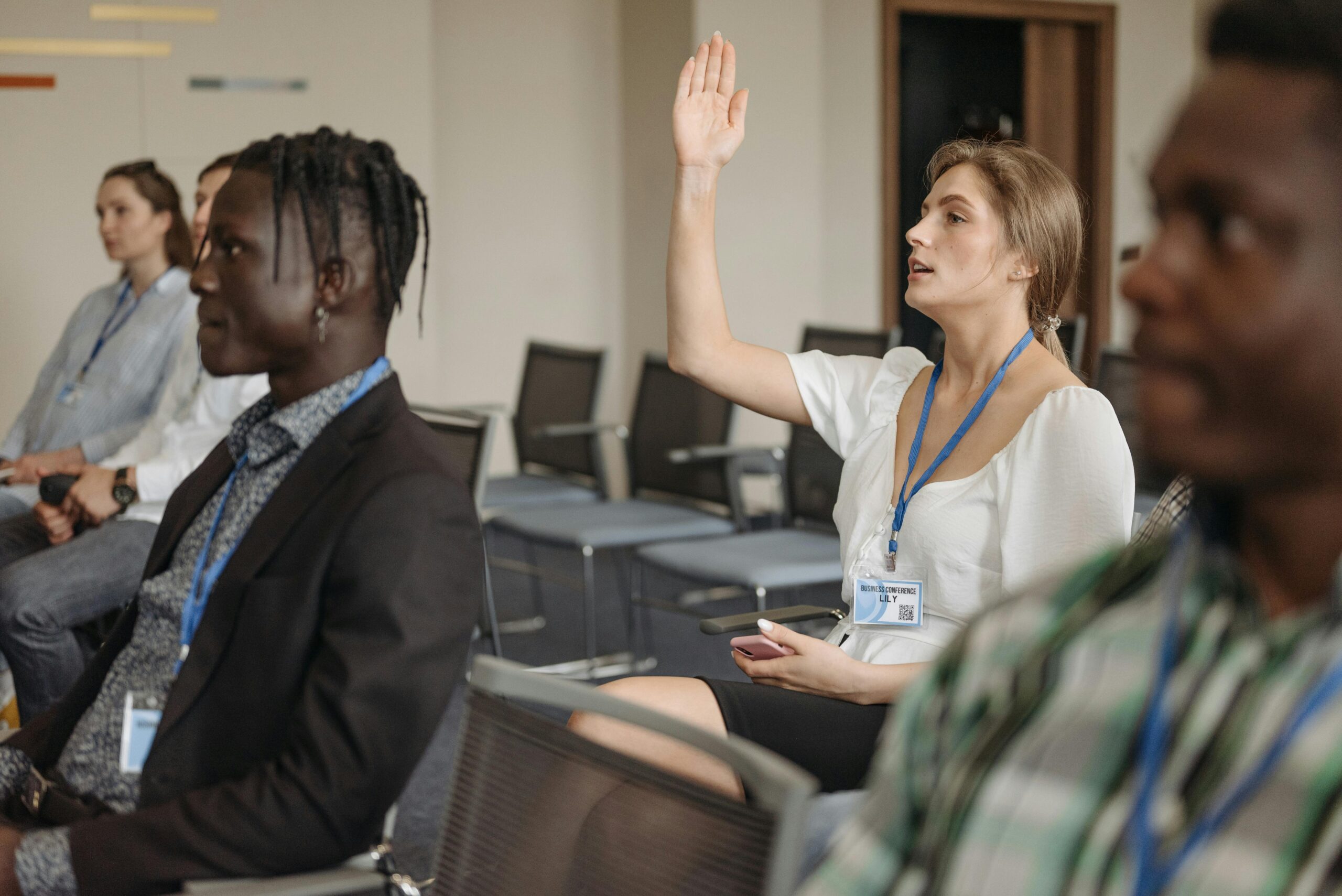 A woman asking sales discovery questions during a meeting.
